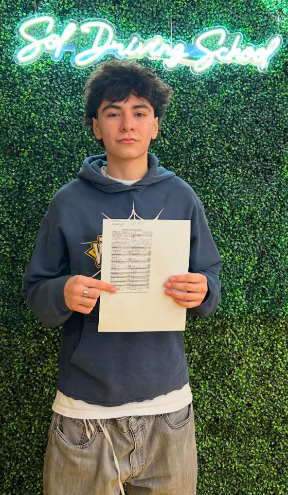 Student with driving test score sheet at SOL Driving School